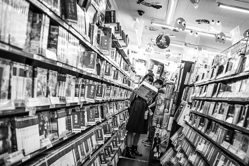 Two women in a Japanese library aisle