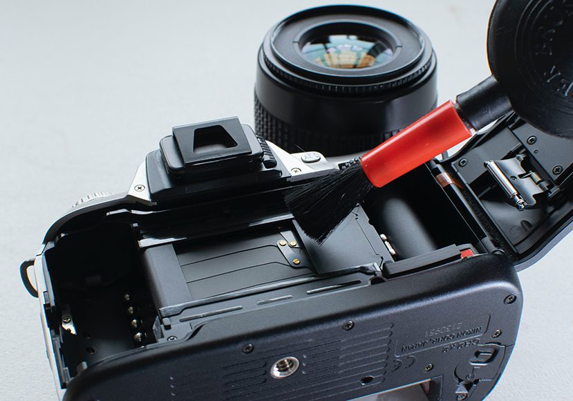 camera being cleaned by brush kit