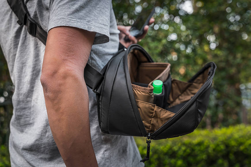 You'll find that the McKinnon Camera Sling sits flat along your body and the lid conveniently stays open without spilling gear!