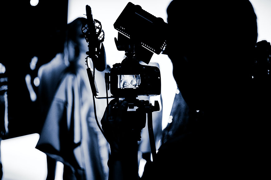 man adjusting on camera light panel at photoshoot