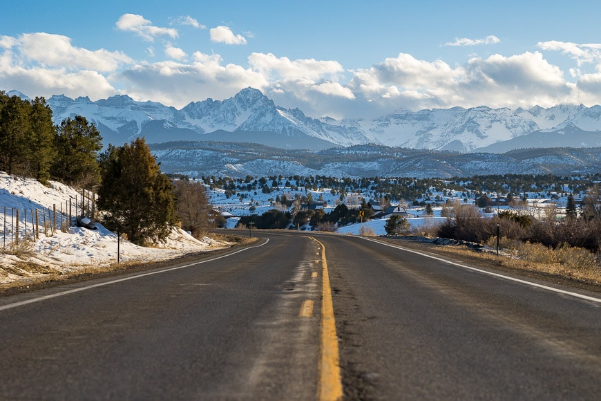 Road snaking off into snow-capped mountains