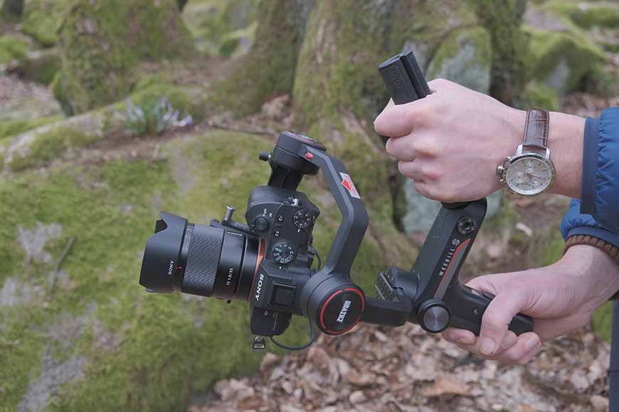 hand-holding camera with zhiyun gimbal